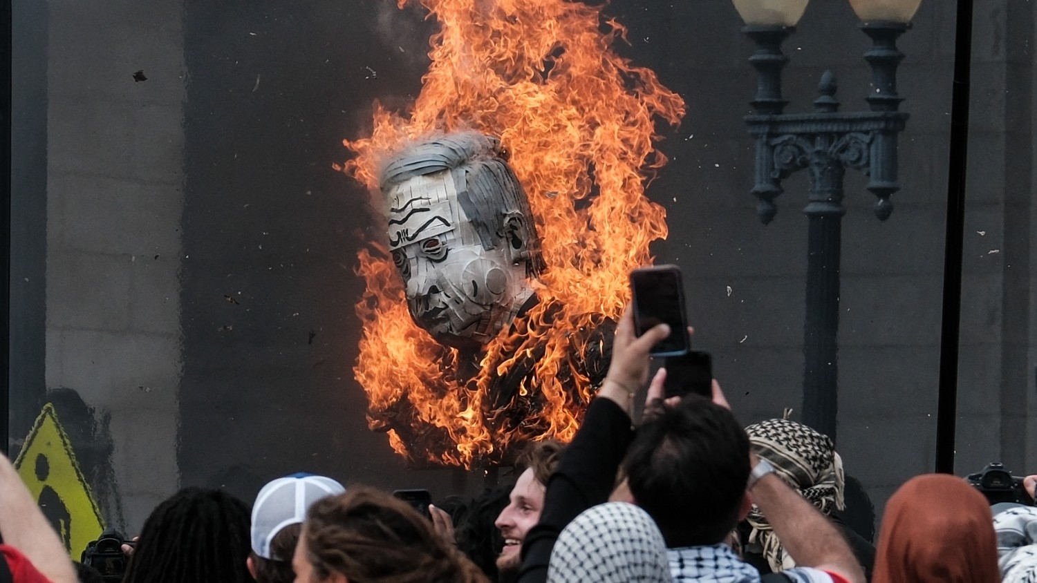 Protestors burn a photo of Benjamin Netanyahu outside of Union Station on 24 July 2024 in Washington DC 