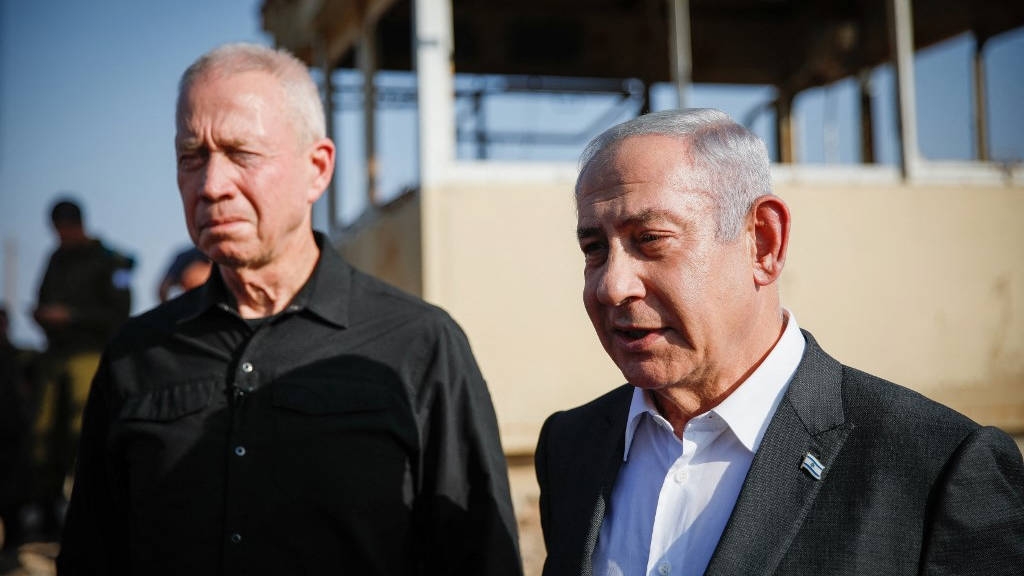Israeli Prime Minister Benjamin Netanyahu (R) and Defence Minister Yoav Gallant arrive at the Salem military post in the occupied West Bank on 4 July, 2023 (AFP)
