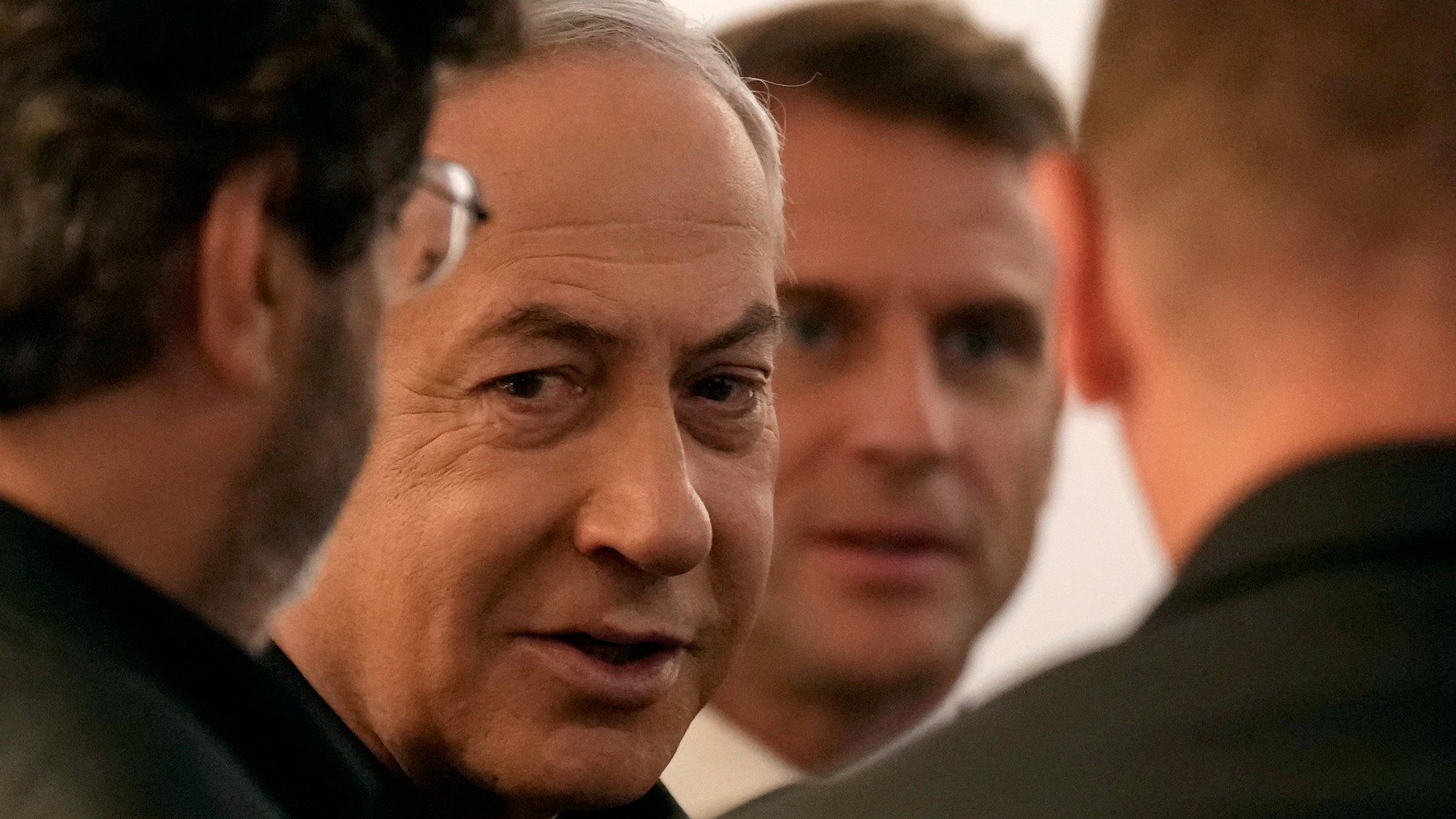 French President Emmanuel Macron departs with Israeli Prime Minister Benjamin Netanyahu for their joint press conference in Jerusalem on 24 October 2023 (AFP)