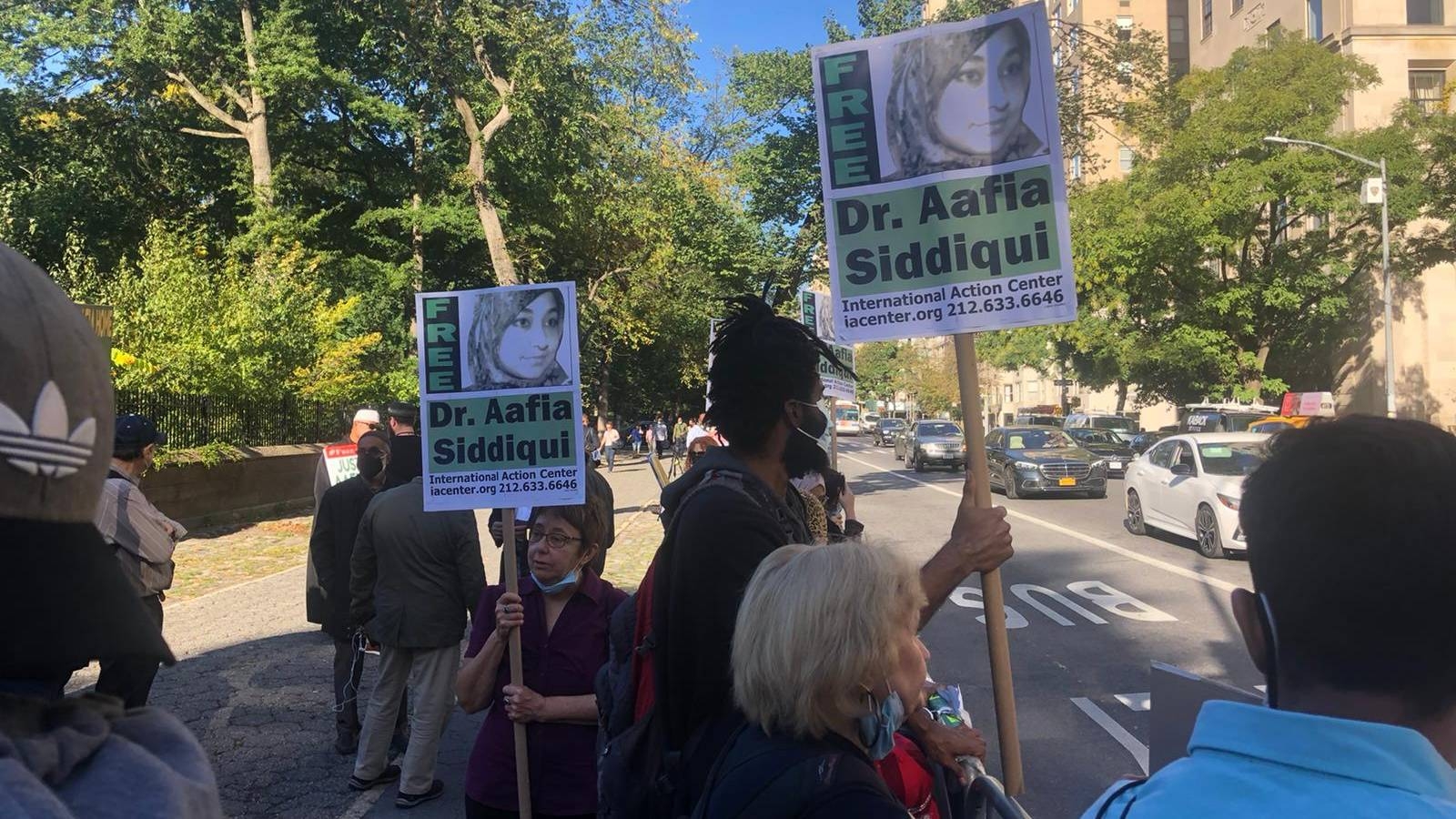 Protesters rally outside the Pakistani consulate in New York City, holding signs reading "Free Dr Aafia Siddiqui".