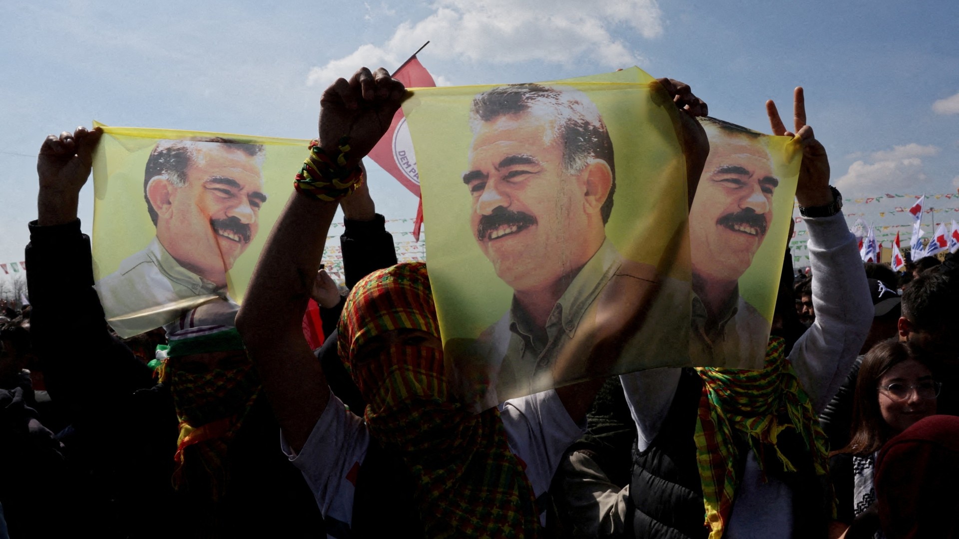 Supporters of pro-Kurdish Dem Party display flags with a portrait of PKK leader Abdullah Ocalan in Istanbul, Turkey, 17 March (Reuters/Umit Bektas)