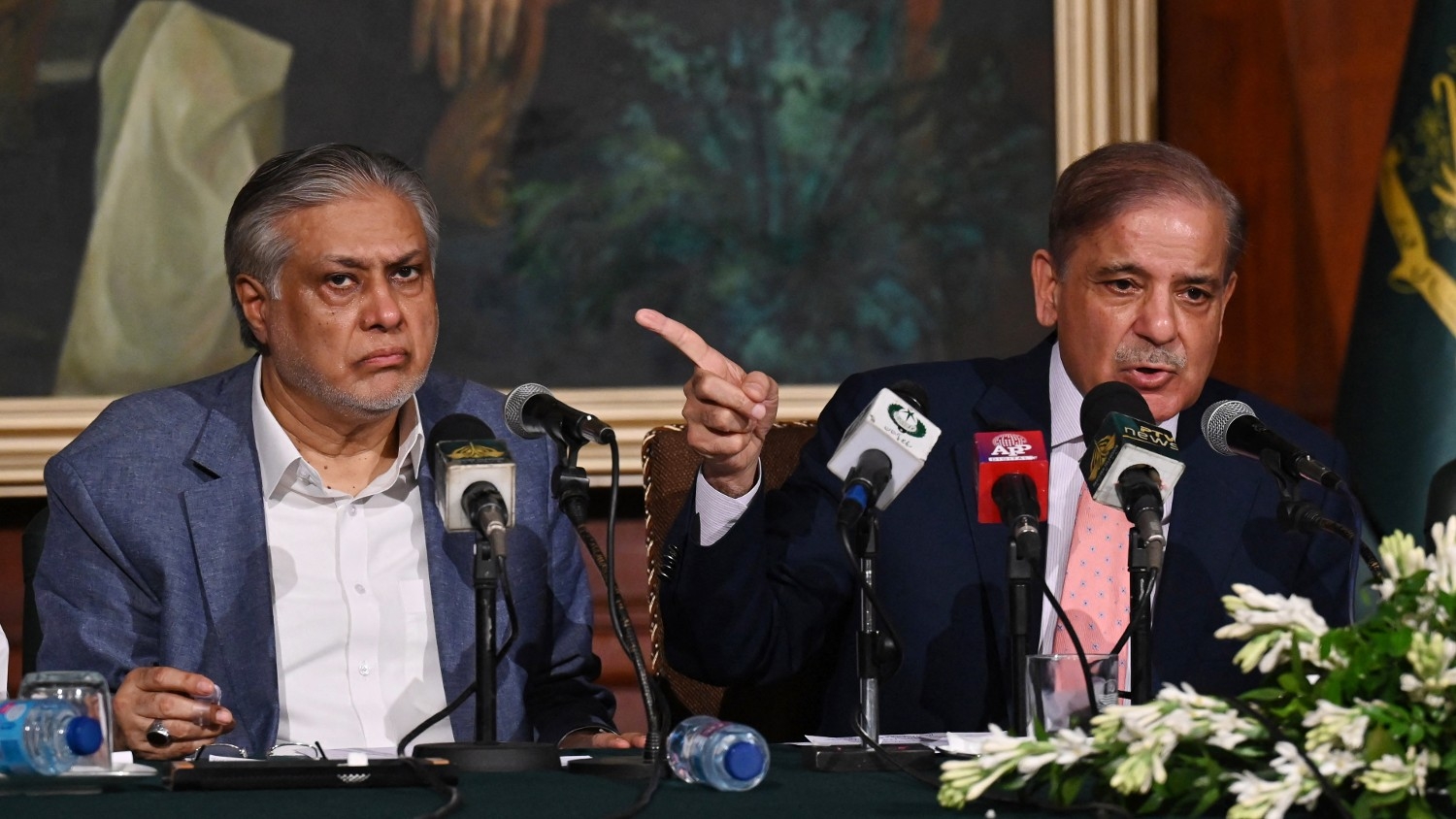 Pakistan's Prime Minister Shehbaz Sharif (R) and Pakistan's Finance Minister Ishaq Dar (L) address a press conference in Lahore on 30 June 2023.
