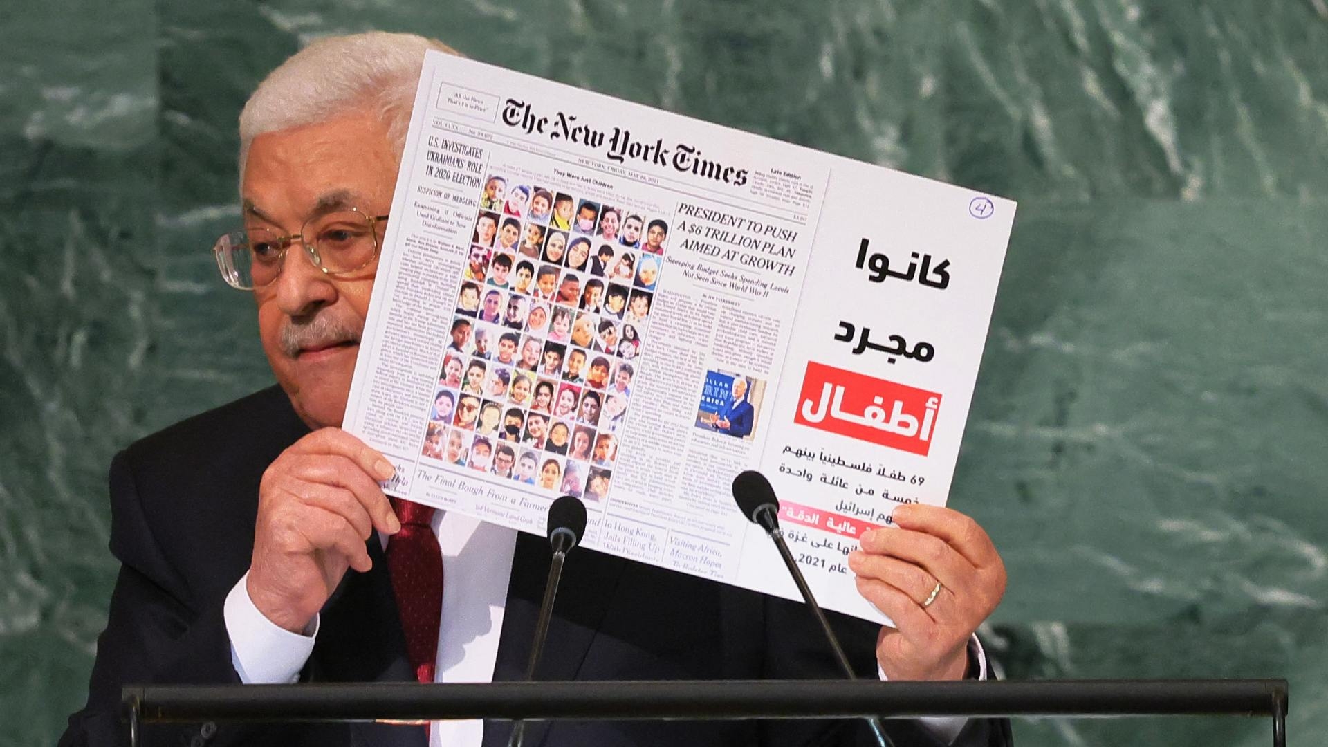 Palestinian President Mahmoud Abbas holds up a photo as he speaks at the 77th session of the UN General Assembly on 23 September 2022 in New York City.