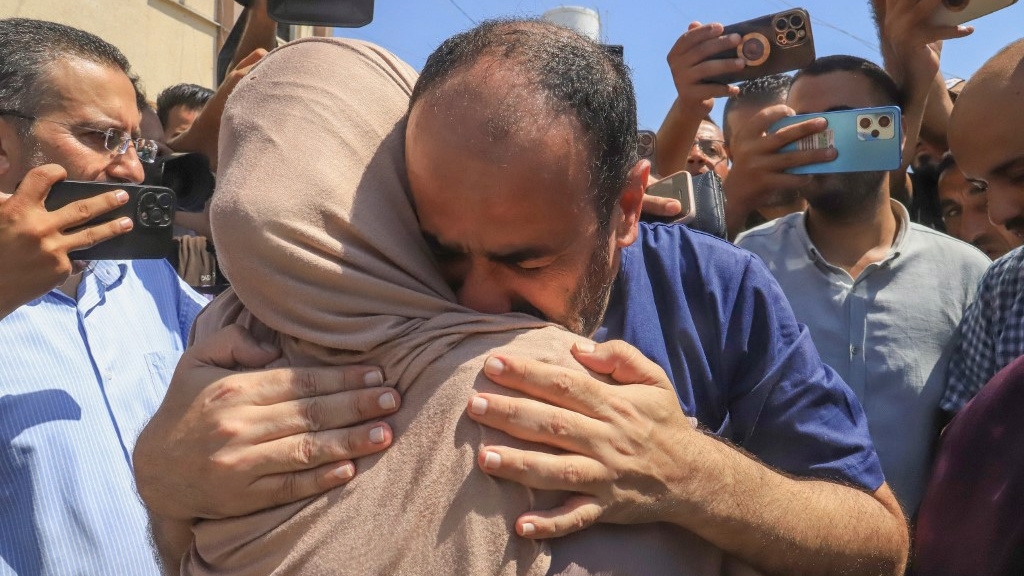 Muhammad Abu Salmiya, the director of al-Shifa hospital, is welcomed by relatives in southern Gaza after his release from an Israeli prison on 1 July 2024 (Bashar Taleb/AFP)