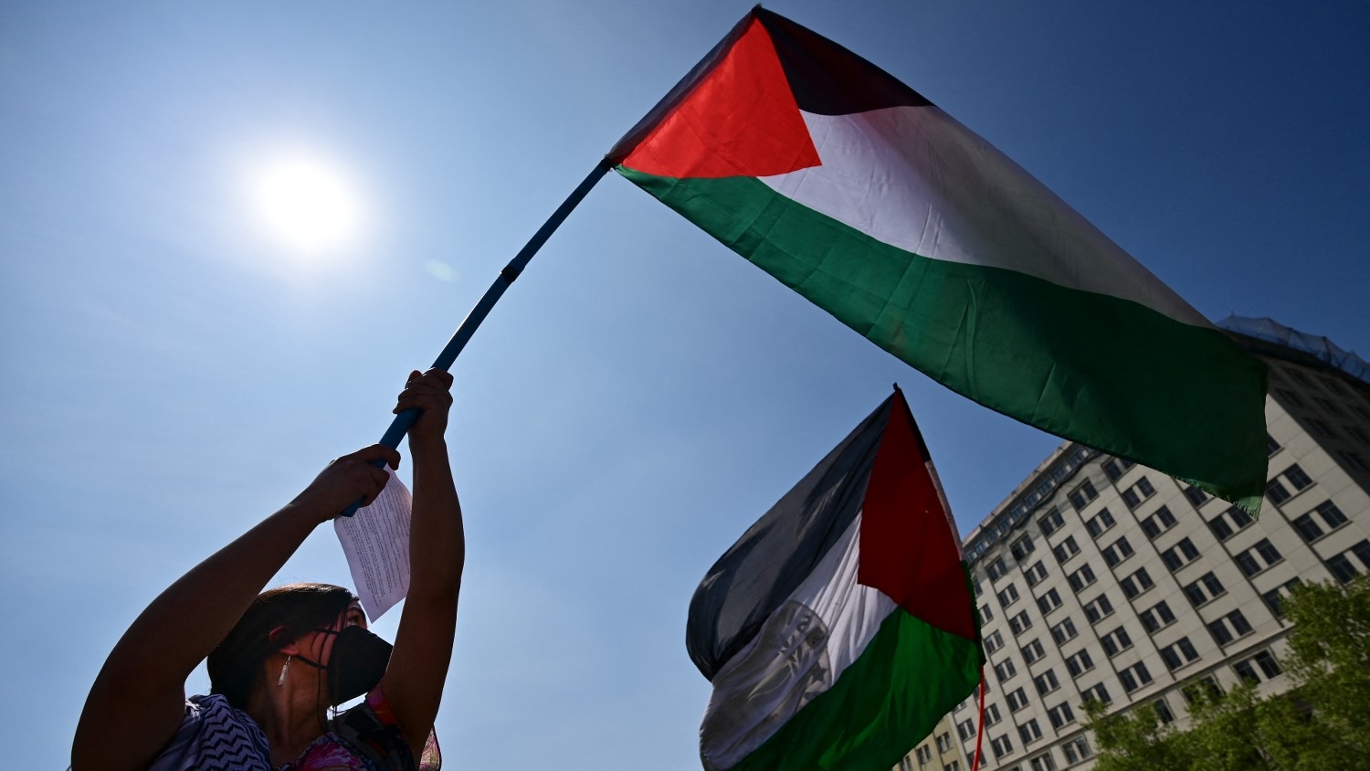 A member of the Palestinian community in Chile waves a Palestinian flag during a demonstration outside La Moneda palace in Santiago on 30 September 2022.