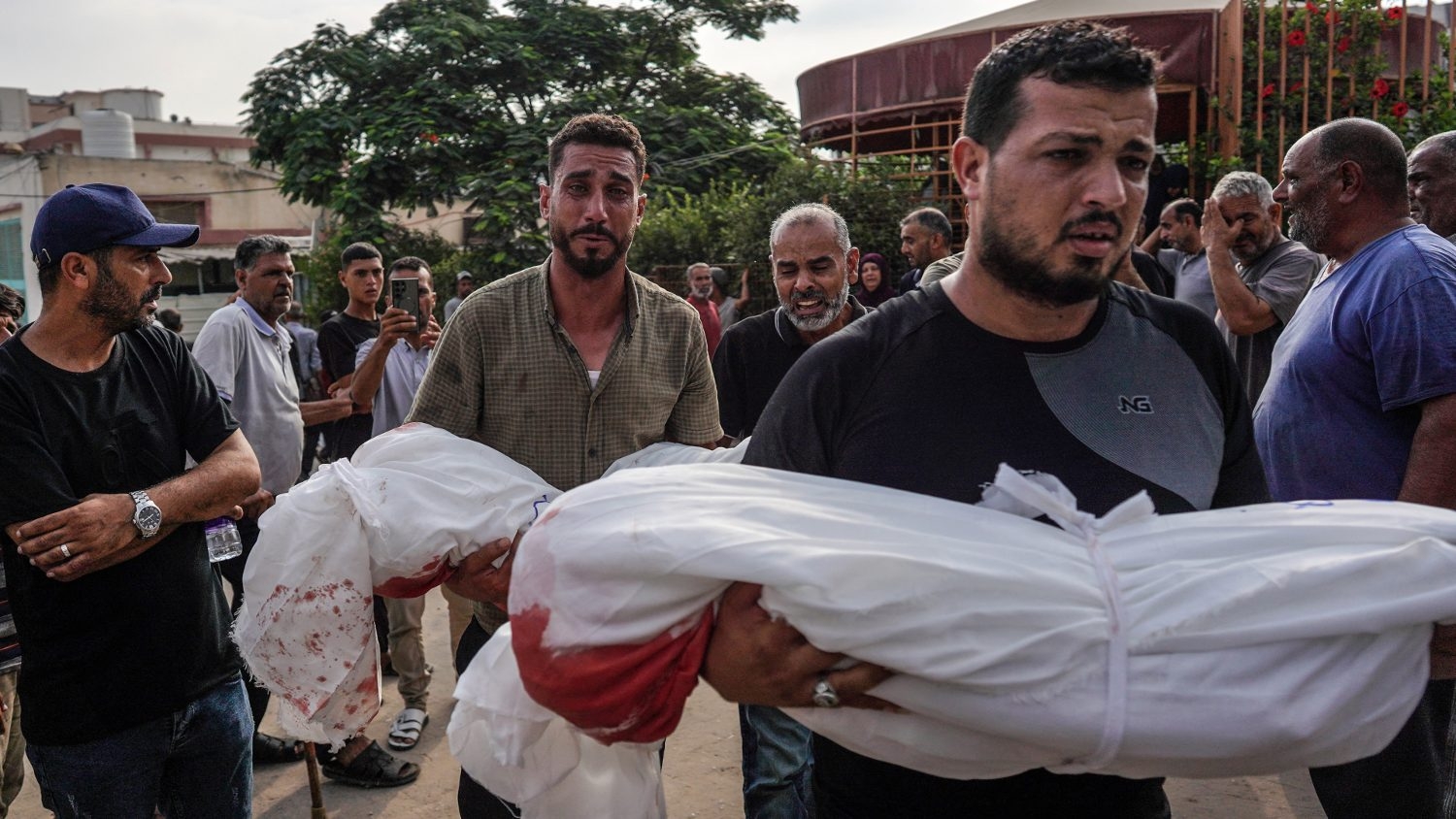 Mourners carry the bodies of members of the Qadih family to a burial ground in Khuzaa in the southern Gaza Strip, following an overnight Israeli strike that hit their house in Bani Suheila on 21 July 2024.