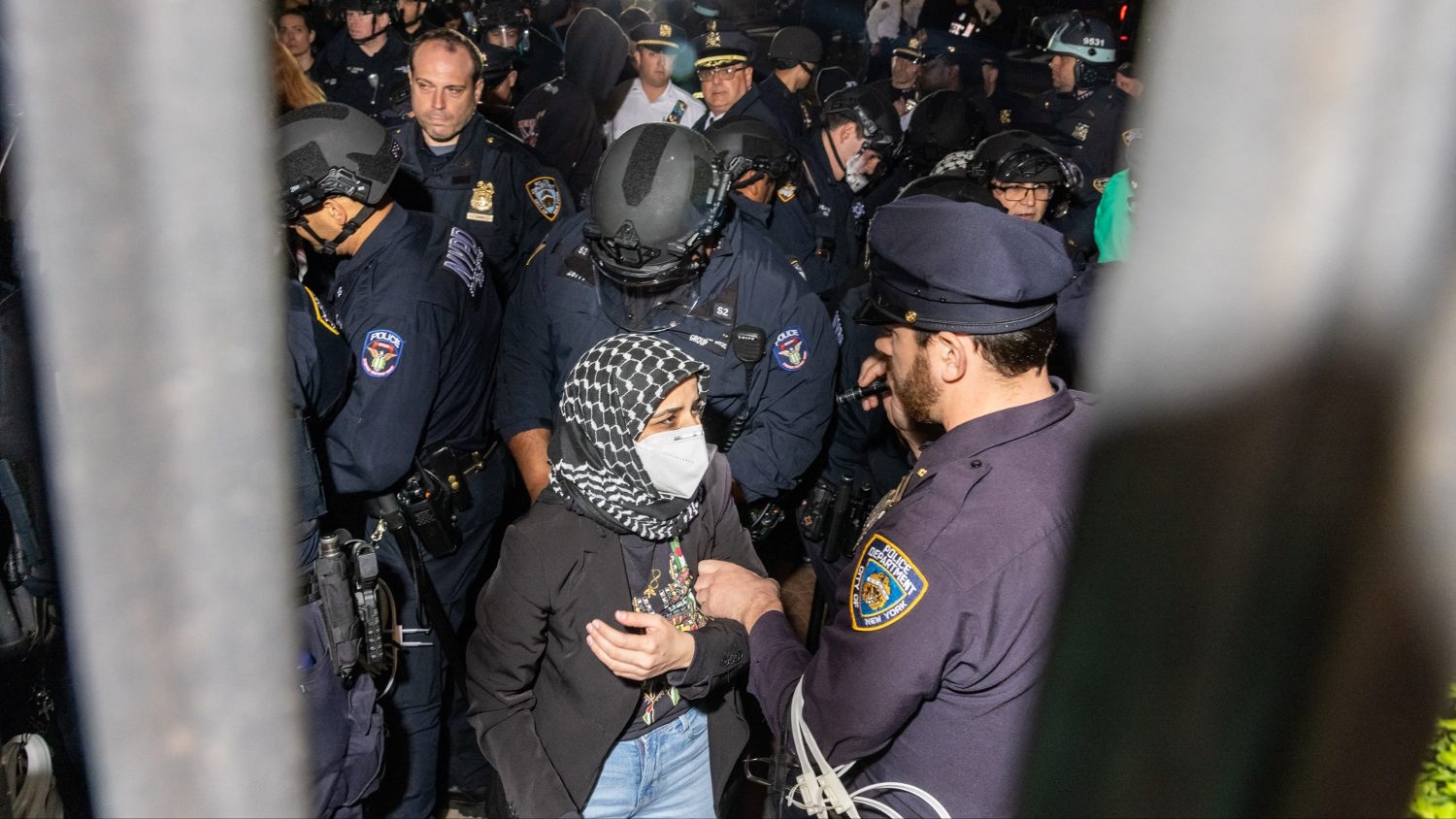 Members of the NYPD arrest protesters blocking the entrance to Columbia University while clearing the pro-Palestinian protest encampment and Hamilton Hall where demonstrators barricaded themselves inside on 30 April 2024.