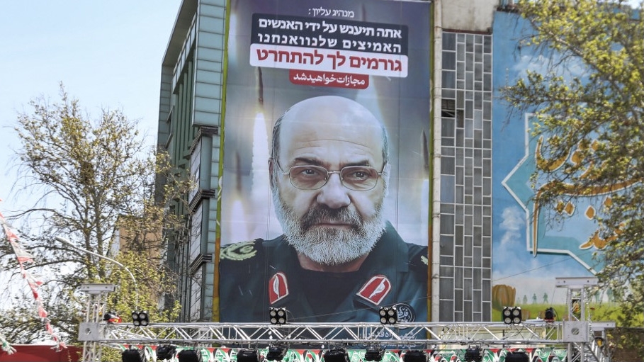 Portrait of slain Iran's Brigadier General Mohammad Reza Zahedi with a slogan in Hebrew saying 'You will be punished', on 3 April 2024 in Tehran, after he was killed in a strike in Damascus on 1 April 2024 (Atta Kenare/AFP)