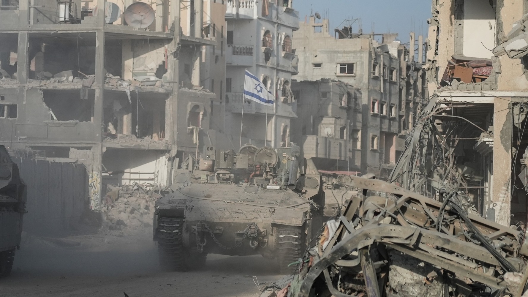 In this image from September, an Israeli tank patrols Rafah flanked by the ruins of buildings (AFP)