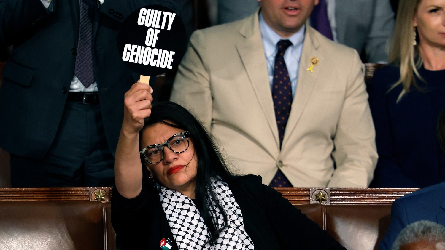 Congresswoman Rashida Tlaib holds a sign reading “Guilty of Genocide” as Israeli Prime Minister Benjamin Netanyahu addresses a joint session of Congress at the US Capitol on 24 July 2024, in Washington, DC