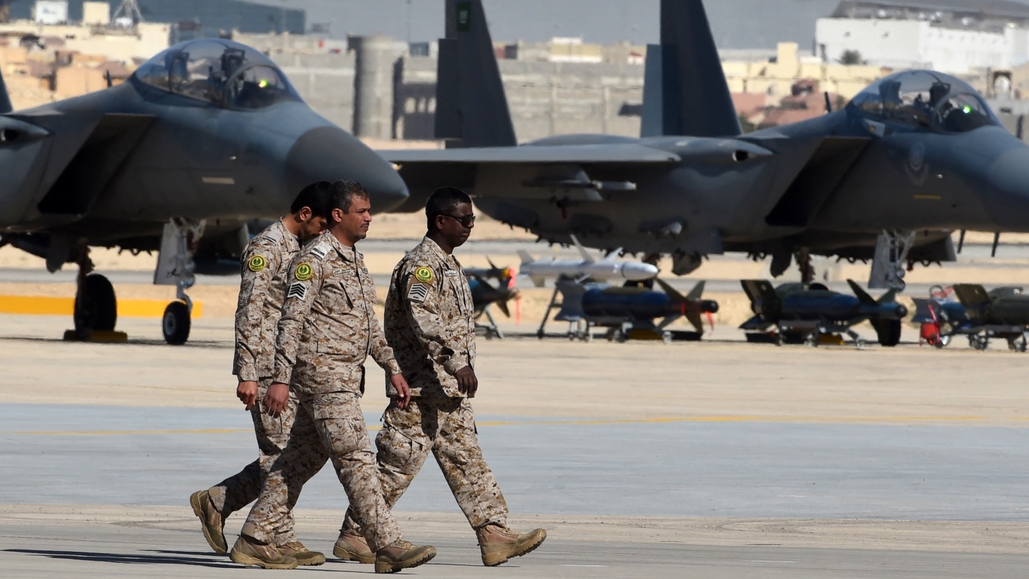 Saudi army officers walk past F-15 fighter jets, GBU bombs and missiles displayed during a ceremony marking the 50th anniversary of the creation of the King Faisal Air Academy at King Salman airbase in Riyadh on 25 January 2017.