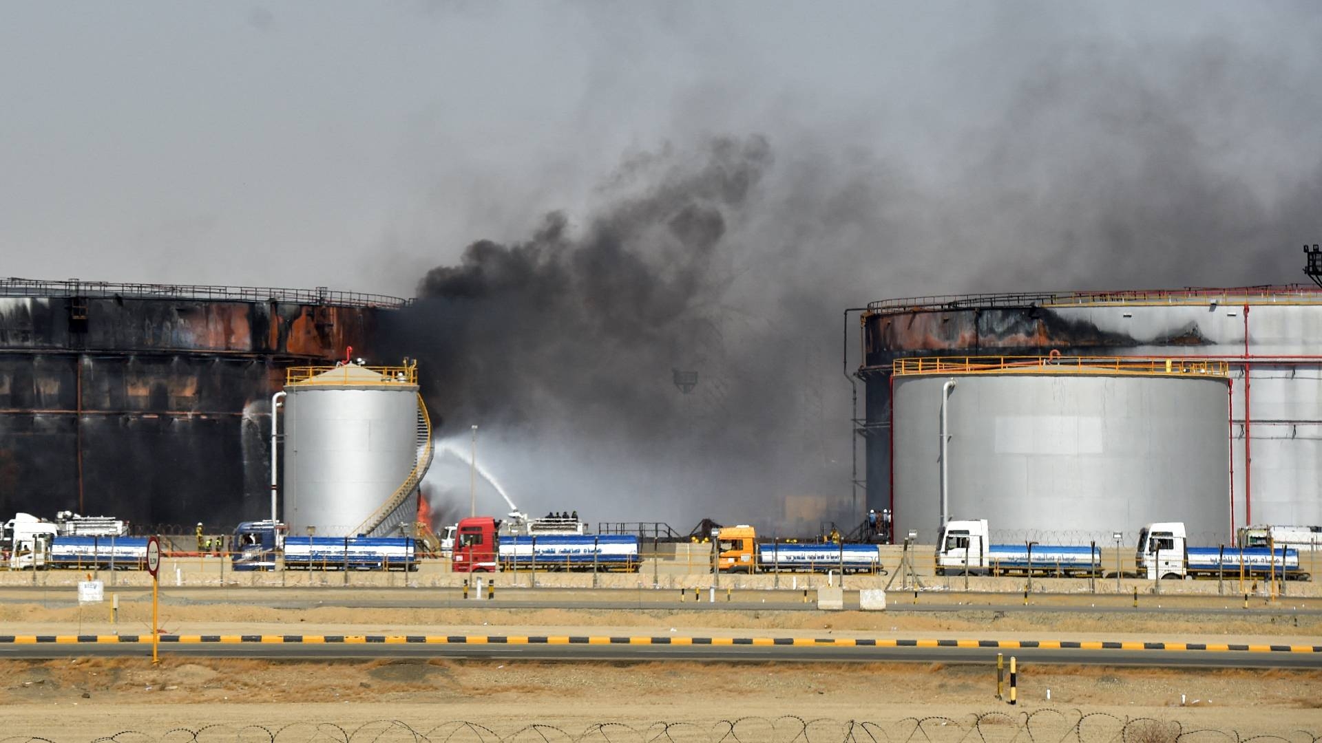 Fire fighters extinguish the last hearths of fire at a Saudi Aramco oil facility in Saudi Arabia's Red Sea coastal city of Jeddah, on 26 March 2022.