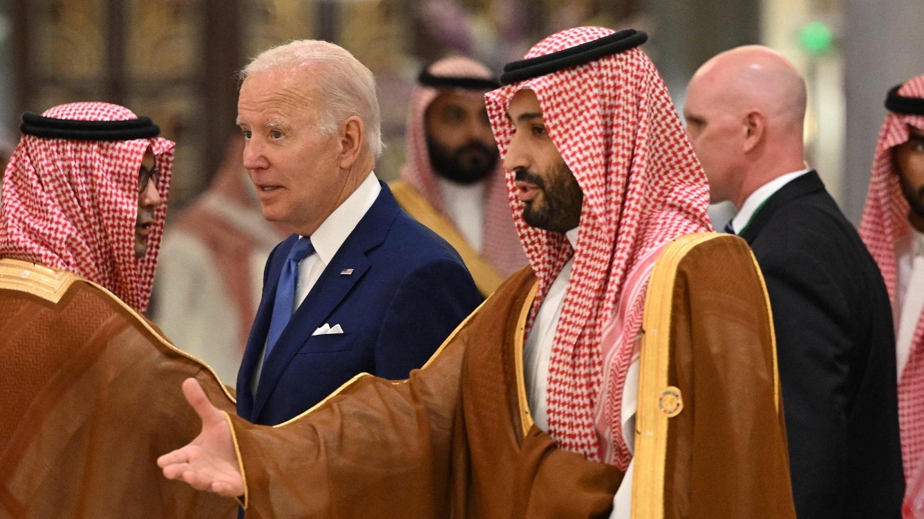 US President Joe Biden and Saudi Crown Prince Mohammed bin Salman walk together at a hotel in Saudi Arabia's Red Sea coastal city of Jeddah on 16 July 2022.