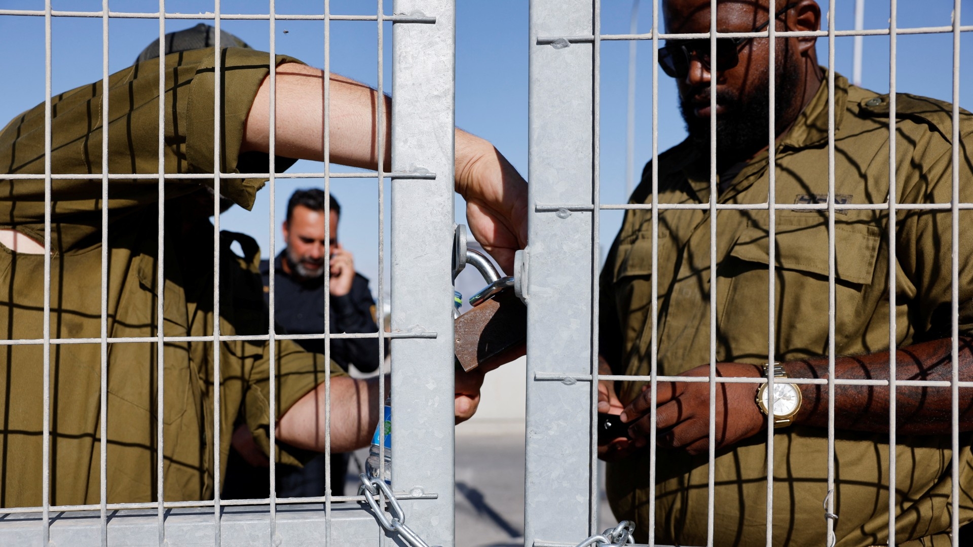 Soldiers lock a gate at Sde Teiman detention facility after Israeli military police arrived as part of an investigation into the abuse of a Palestinian detainee, on 29 July 2024 (Amir Cohen/Reuters)