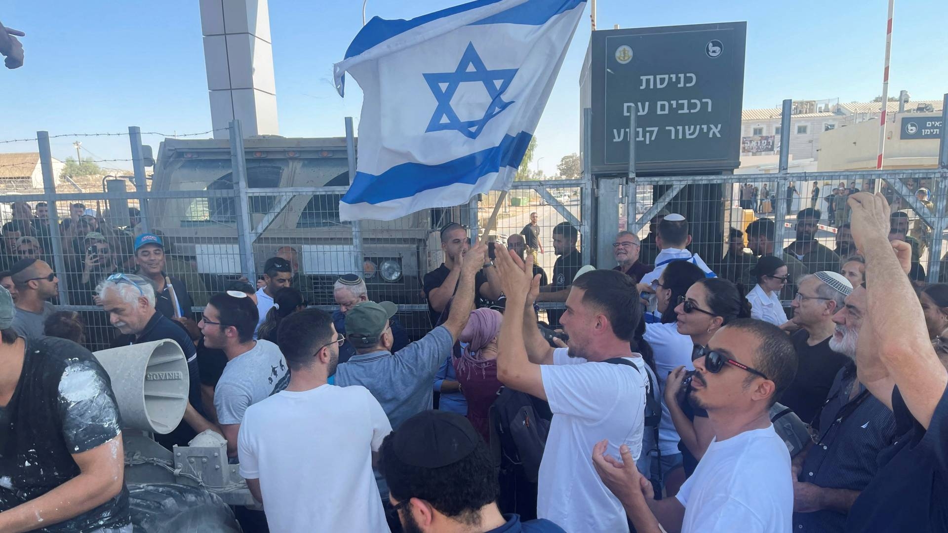 Israeli protesters wave flags outside the Sde Teiman detention facility after Israeli soldiers had been arrested, 29 July (Reuters)