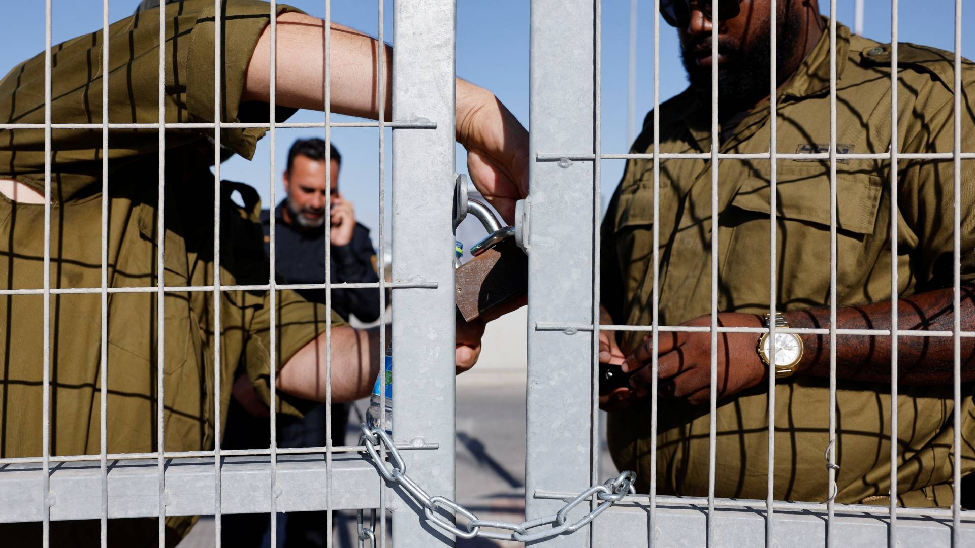 Soldiers lock a gate from the inside at Sde Teiman detention facility, after Israeli military police arrived at the site as part of an investigation into the suspected abuse of a Palestinian detainee on 29 July (Reuters)