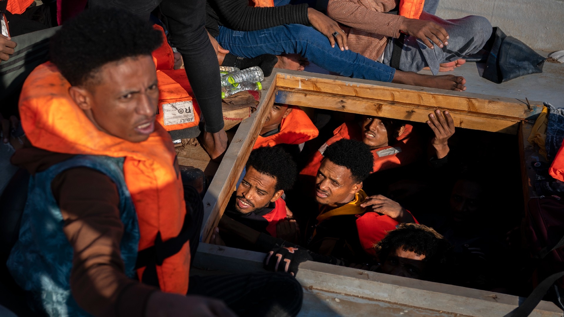Migrants from Eritrea, Libya and Sudan are crowded in the hold of a wooden boat before being assisted by aid workers of the Spanish NGO Open Arms, in the Mediterranean sea, about 30 miles north of Libya on June 17, 2023. (AP)