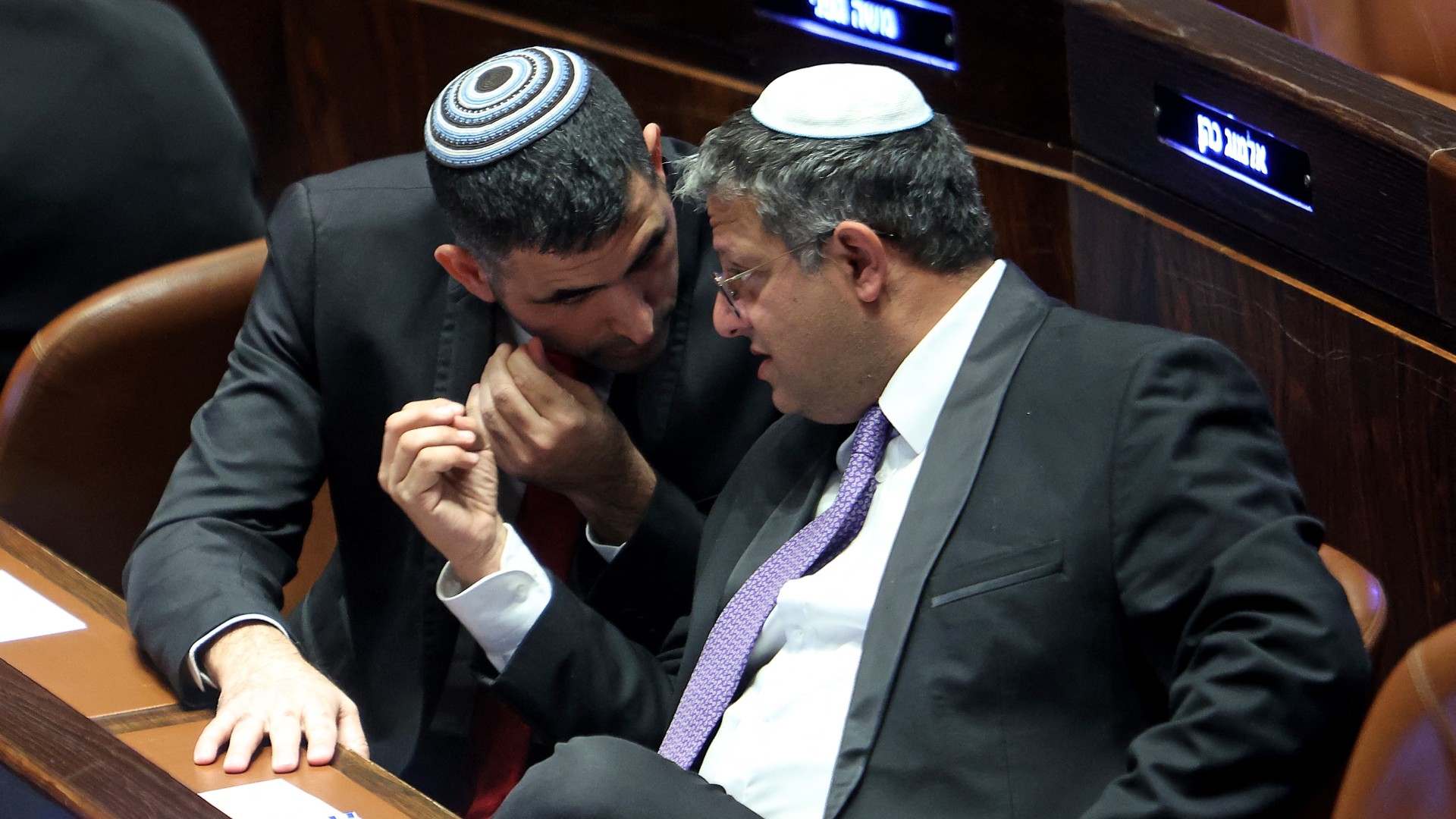 Israeli Knesset member Itamar Ben-Gvir (R), with the Likud party's Shlomo Karhi (L) during a parliament session in Jerusalem on 13 December 2022 (AFP)