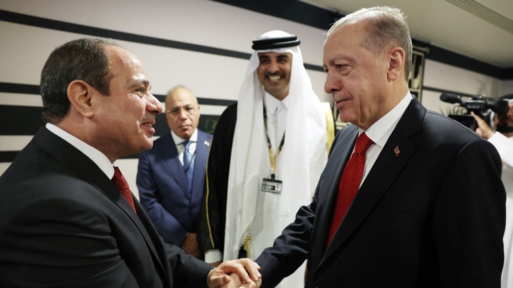 This handout photograph taken and released by The Press Office of the Presidency of Turkey on 20 November 2022, shows Turkish President Recep Tayyip Erdogan (R) shakes hands with Egyptian President Abdel Fattah el-Sisi as they are welcomed by Qatari Emir Sheikh Tamim bin Hamad al-Thani (2ndR) on the occasion of the opening ceremony of the 2022 FIFA World Cup in Doha, Qatar (AFP)