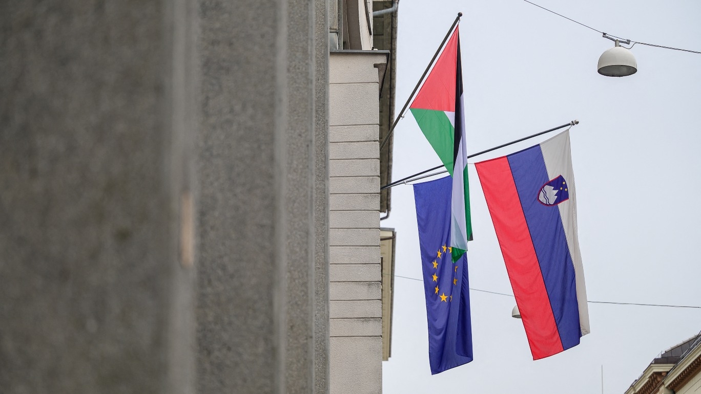 This photograph taken in Ljubljana on 30 May 2024 shows a Palestinian flag next to the Slovenian and European flags on the Government Building.