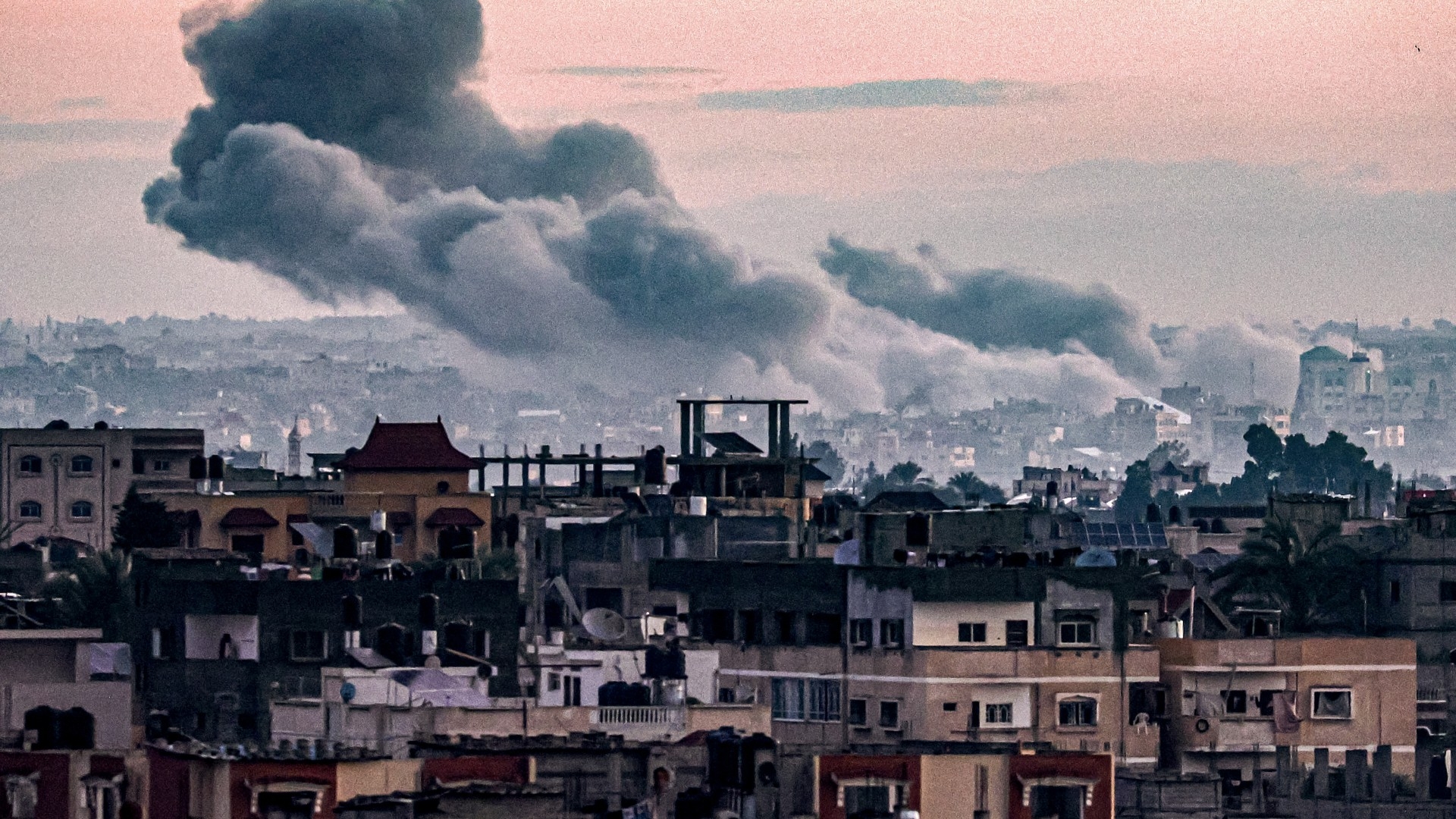 Smoke billows during Israeli bombardment on Khan Yunis from Rafah in the southern Gaza Strip early on 3 January 2024 (AFP)