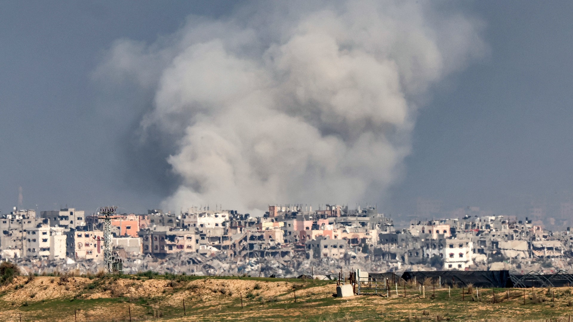 A smoke plume erupts during Israeli bombardment on the northern Gaza Strip near the border with southern Israel on 17 December 2023 (Jack Guez/AFP)