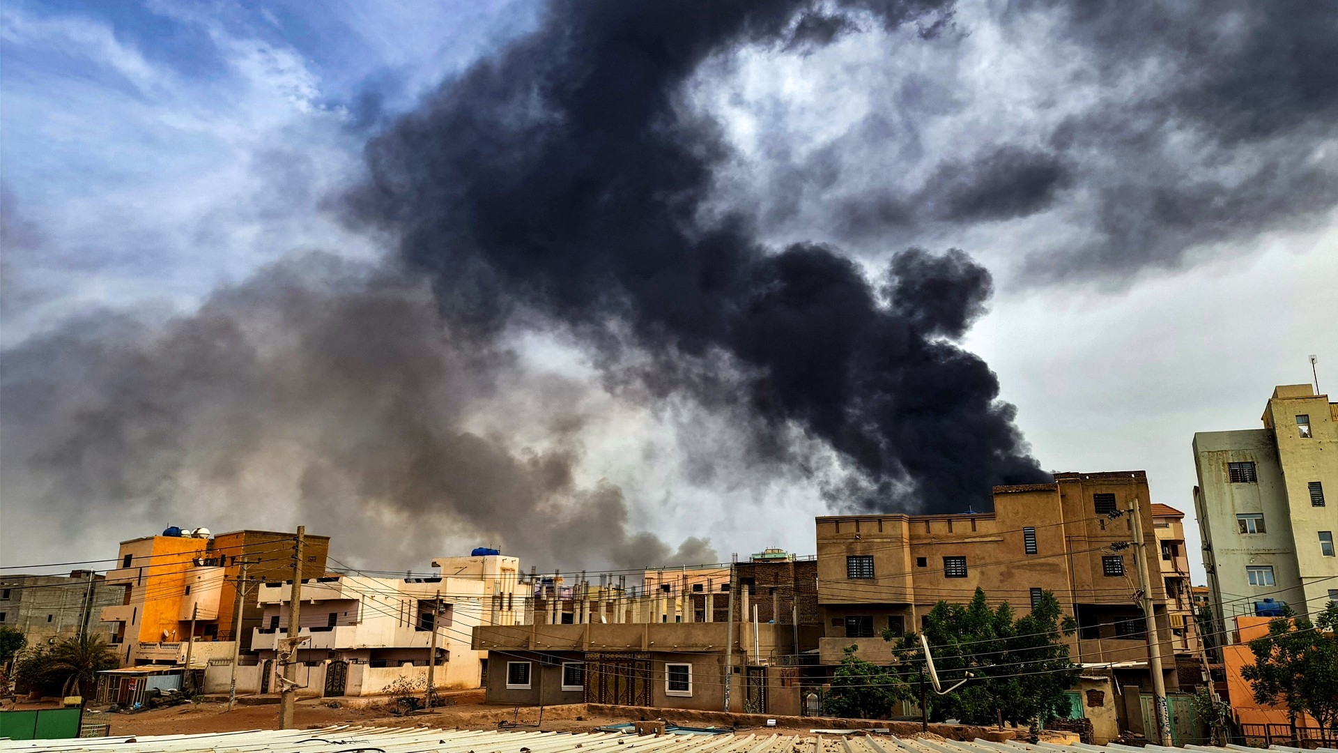 Smoke plumes billow from a fire at a warehouse in southern Khartoum amidst ongoing fighting on 7 June 2023 (AFP)