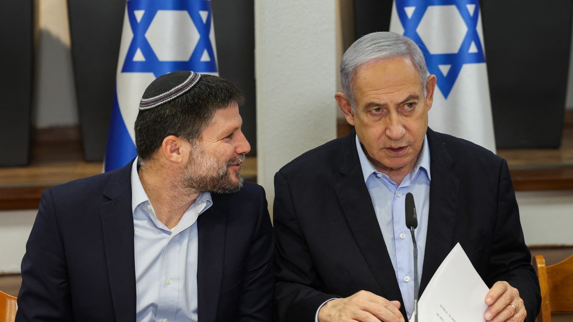 Israeli Prime Minister Benjamin Netanyahu (R) and Minister of Finance Bezalel Smotrich attend the weekly cabinet meeting in Tel Aviv on 7 January (Ronen Zvulun/AFP)