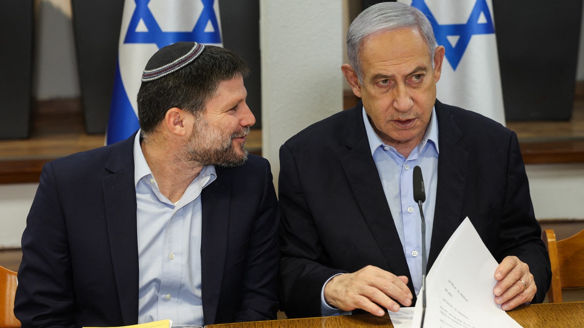 Israeli Prime Minister Benjamin Netanyahu and Minister of Finance Bezalel Smotrich attend the weekly cabinet meeting at the Defence Ministry in Tel Aviv on 7 January 2024 (AFP/Ronen Zvulun)