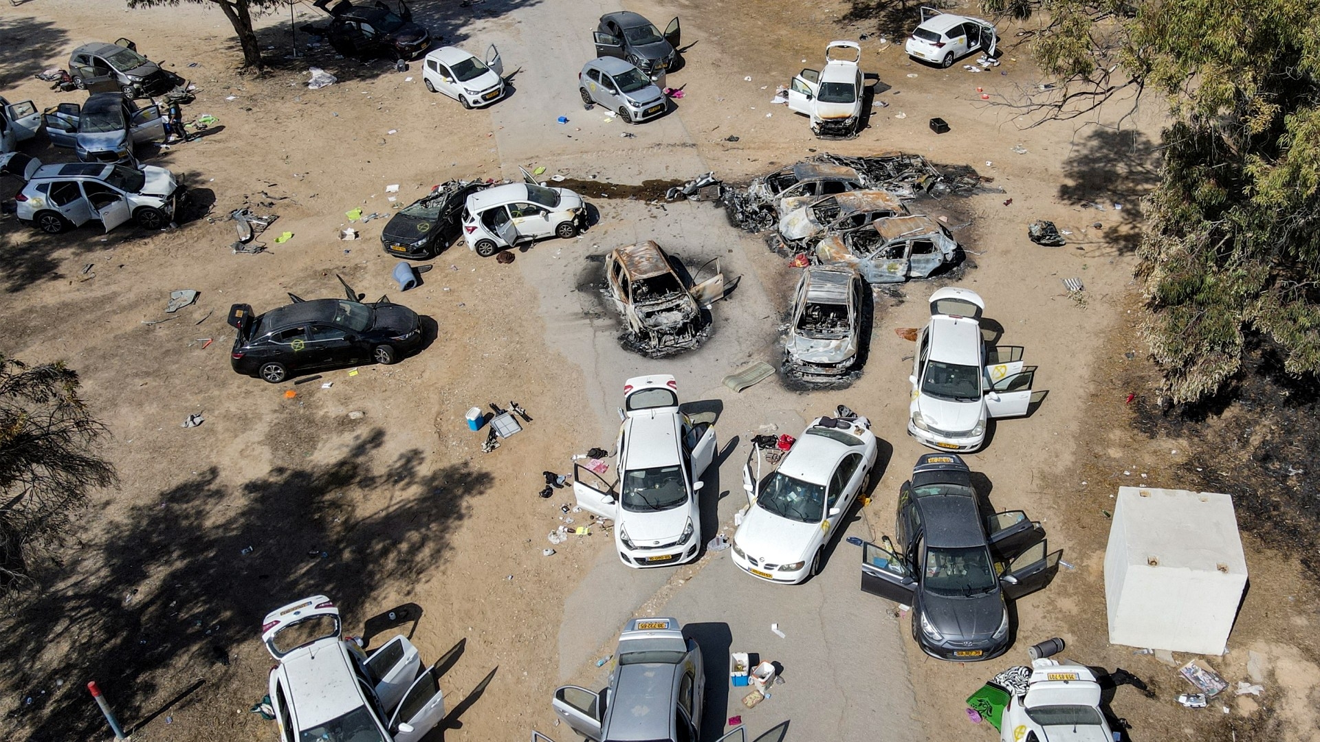 Abandoned and torched vehicles at the site of the October 7 attack by Palestinian militants near Kibbutz Reim in the Negev desert in southern Israel on 13 October 2023 (AFP/Jack Guez)