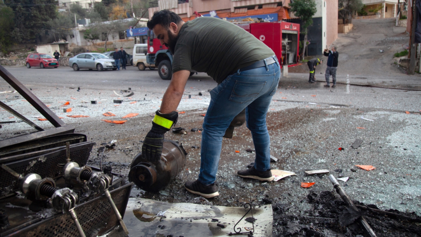 Emergency service members work at the site of an israeli airstrike on a supermarket and coffeeshop in south lebanon