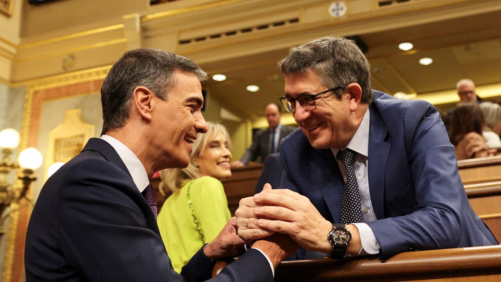Spanish Prime Minister Pedro Sanchez interacts with Patxi Lopez, member of the Spanish Socialist party PSOE, during a plenary session of the lower house of the Spanish parliament, in Madrid, Spain, 22 May 2024 (Reuters)