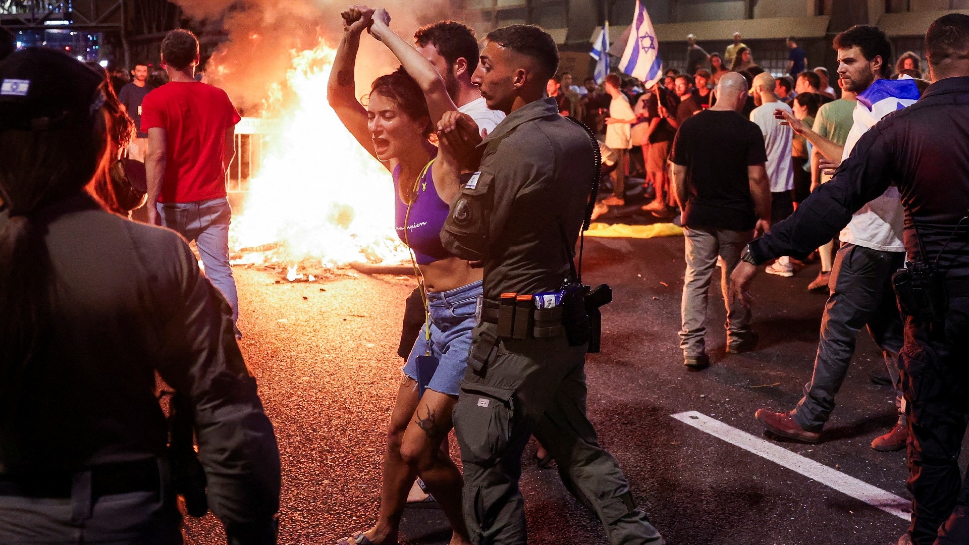 A person reacts as protesters rally against the government in Tel Aviv, 1 September (Reuters)