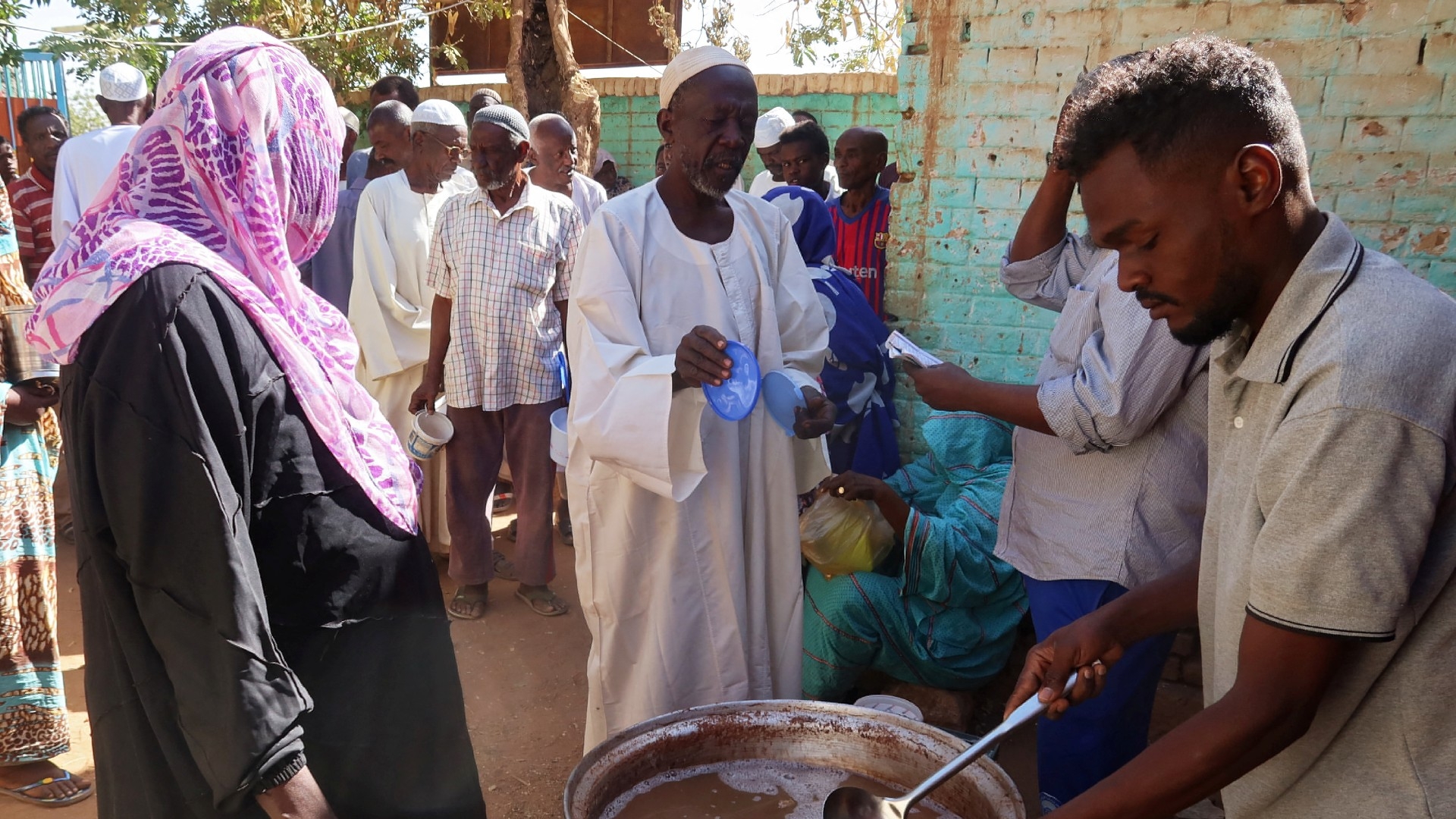 Volunteers distribute food to residents and displaced people in Omdurman, Sudan, 8 March 2024. Nearly five million people in the country are close to famine as Sudan's civil war passes the one-year mark (Reuters/El Tayeb Siddig)