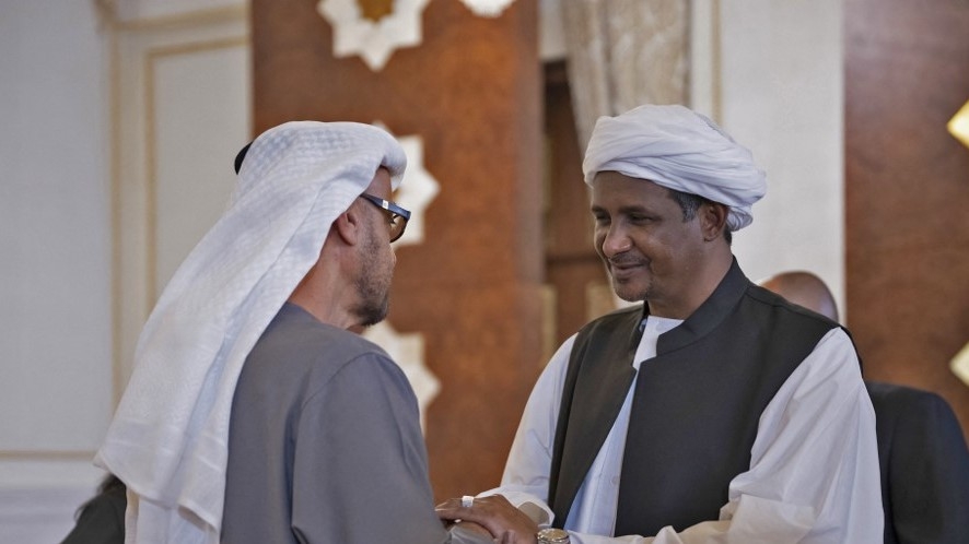 Mohamed Hamdan Dagalo “Hemeti” (R), then deputy chairman of Sudan’s Sovereign Council, pays respects to Mohammed bin Zayed Al Nahyan (L), the ruler of Abu Dhabi and president of the UAE, at the Presidential Airport in Abu Dhabi on 15 May 2022 (AFP)