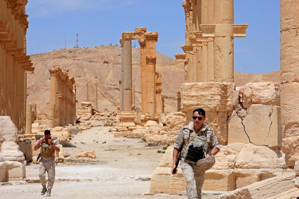 Russian forces walk in the ancient Syrian city of Palmyra on 9 May, 2022 (AFP)