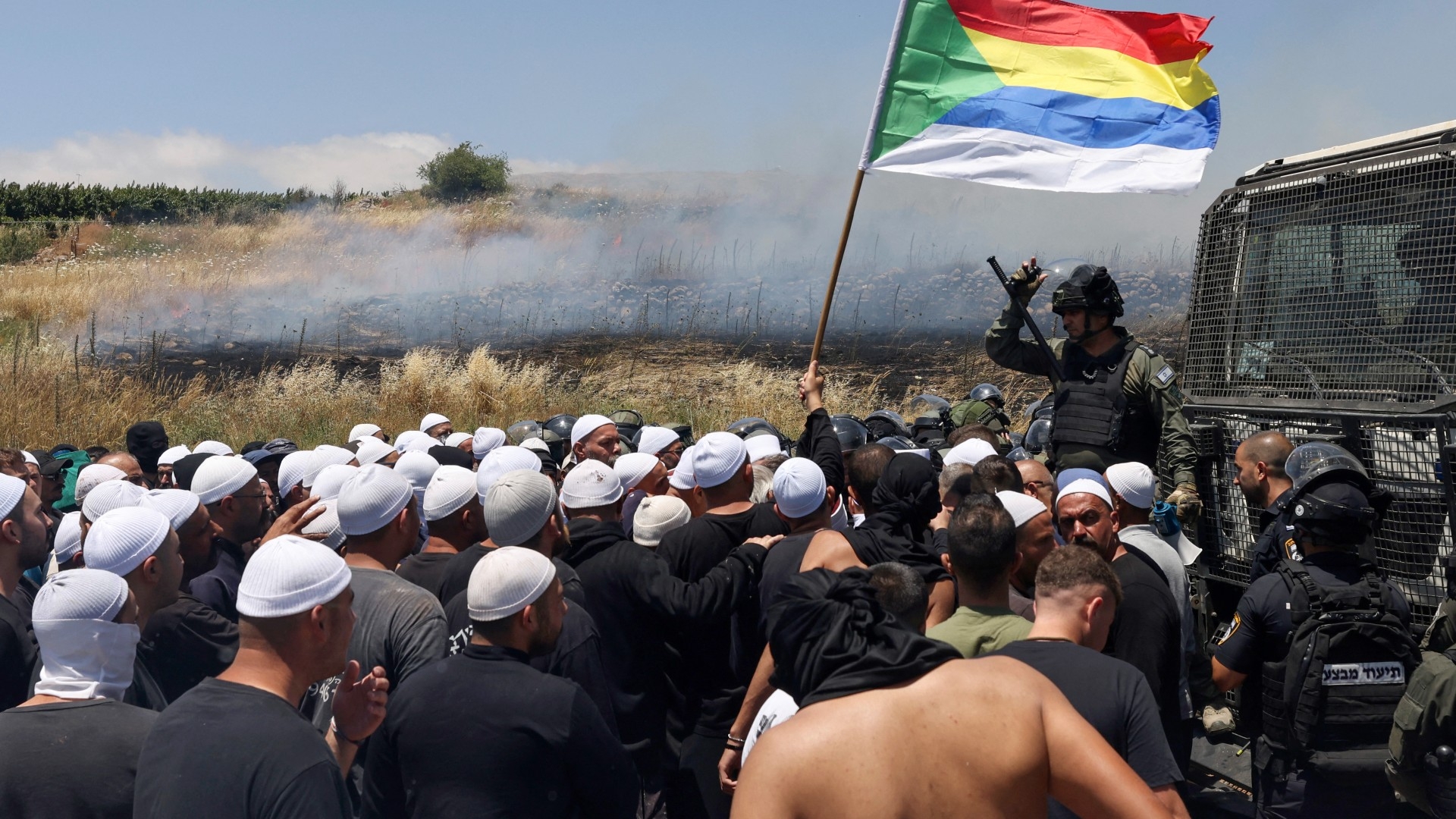 Israeli security forces disperse a protest near the Syrian Druze village of Majdal Shams in the occupied Golan Heights on 20 June 2023 (AFP)