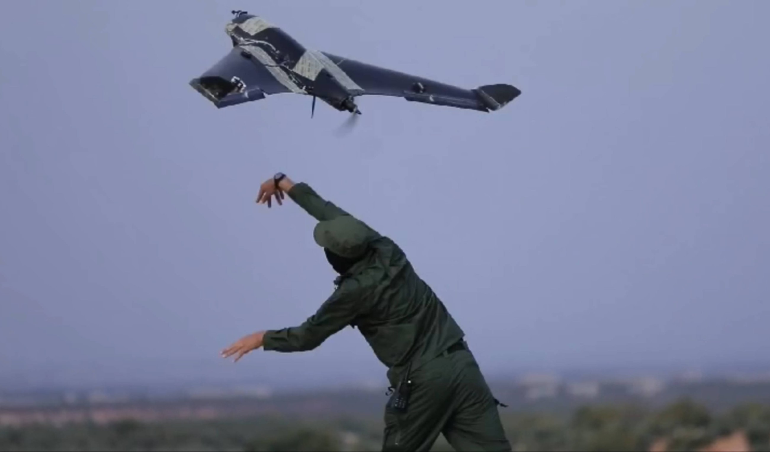 A screenshot from a video published by Hay'at Tahrir al-Sham shows a rebel fighter launching a Shaheen suicide drone (MEE)