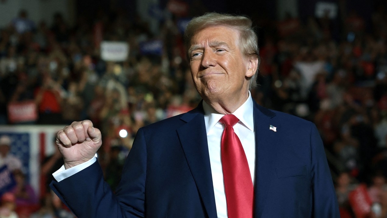 Republican presidential nominee, former U.S. President Donald Trump reacts to supporters as he arrives for a campaign rally at East Carolina University on 21 October 2024 in Greenville, North Carolina.