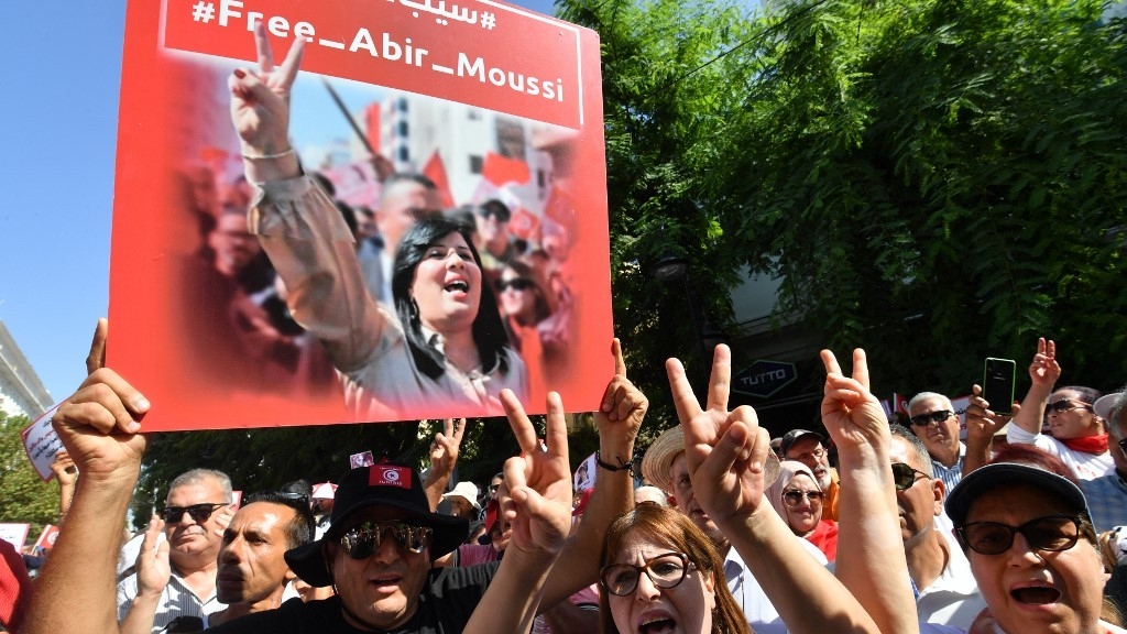 Supporters of the president of the Free Destourian Party (PDL) Abir Moussi hold up her image as they demand her release during a demonstration organized in Tunis on 15 October 2023 (AFP)