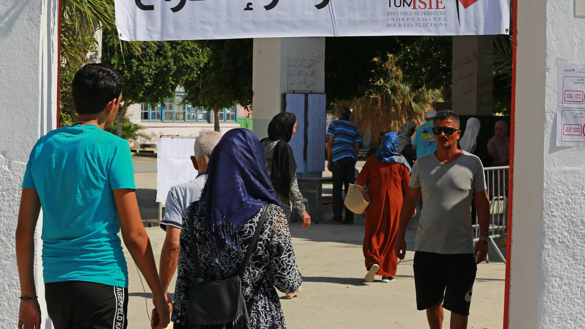 Tunisians arrive to vote in a referendum on a draft constitution put forward by the country's president, at a polling station in Ben Arous region near Tunis, on 25 July 2022.