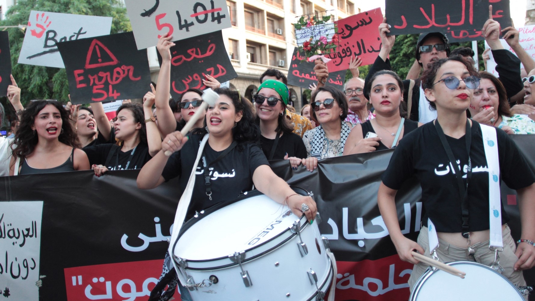 Tunisian feminists call for the release of women arrested for criticising President Kais Saied at a rally in Tunis on 13 August (AFP)