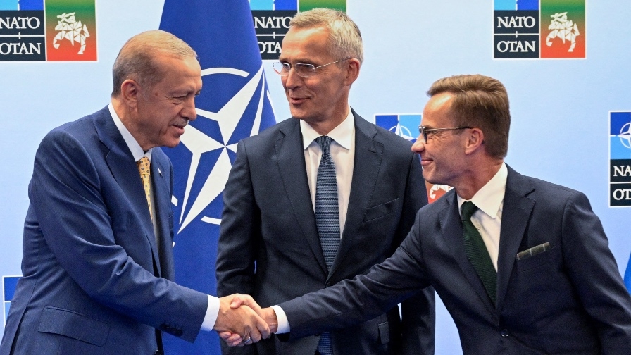 Turkish President Tayyip Erdogan and Swedish Prime Minister Ulf Kristersson shake hands next to Nato secretary general Jens Stoltenberg on eve of Nato summit, in Vilnius, Lithuania, on 10 July 2023.