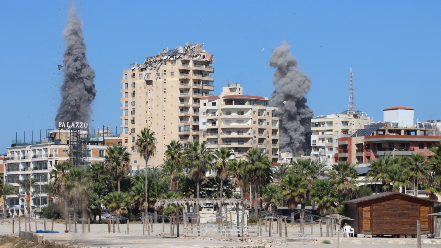 Smoke plumes erupt following an Israeli air strike on a neighbourhood of Lebanon's southern city of Tyre on 23 October 2024 (Kawnat Haju/AFP)