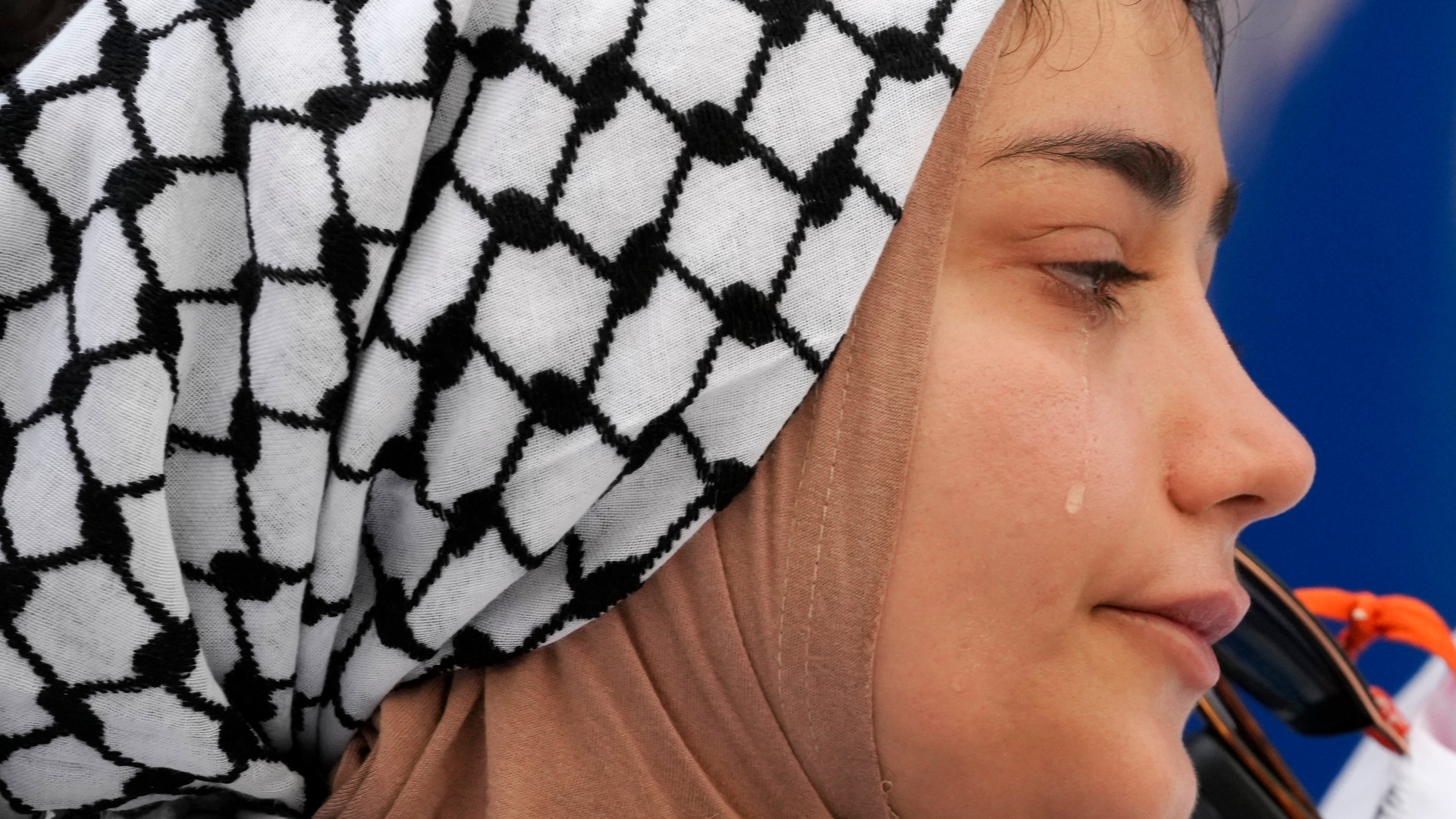 A woman cries as names of dead Palestinian children are read during a protest to demand a ceasefire at the Cop28 UN Climate Summit, Sunday, 3 December 2023, in Dubai, United Arab Emirates (AP)