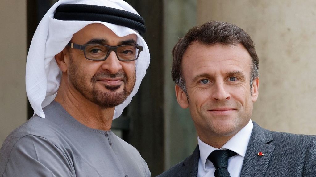 French President Emmanuel Macron (R) greets UAE President Mohammed bin Zayed in Paris on 11 May 2023 (AFP)