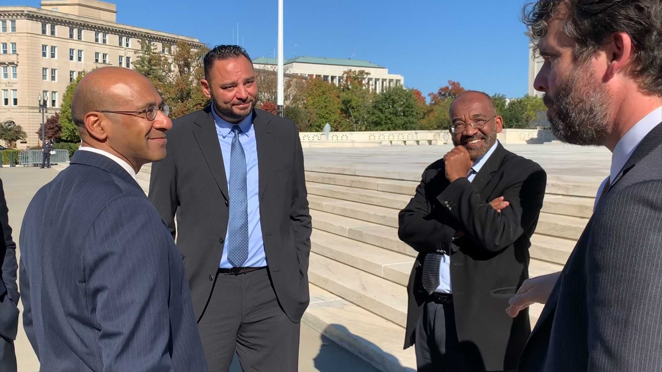 Yasser Abdelrahim (2nd from left) and Yassir Fazaga (3rd from left) stand outside the Supreme Court with their lawyers after oral arguments on 8 November 2021.