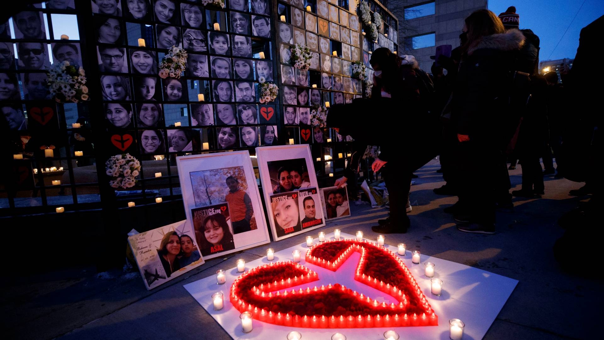 Mourners attend an outdoor vigil for the victims of Ukrainian passenger jet flight PS752 in Toronto, Ontario, Canada on 8 January 2022.