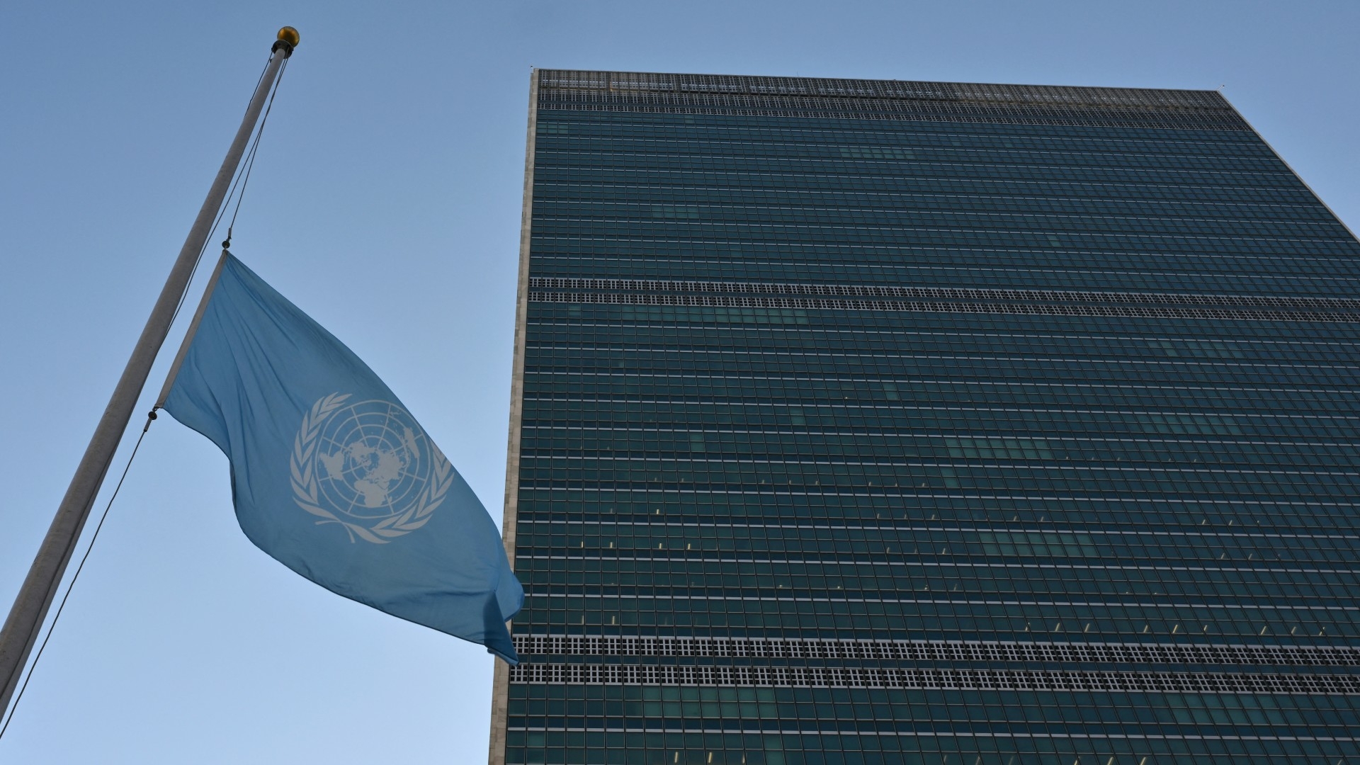 Flags fly at half-mast at the United Nations headquarters in New York on 13 November, 2023 in honour of colleagues killed in Gaza (AFP/Angela Weiss)