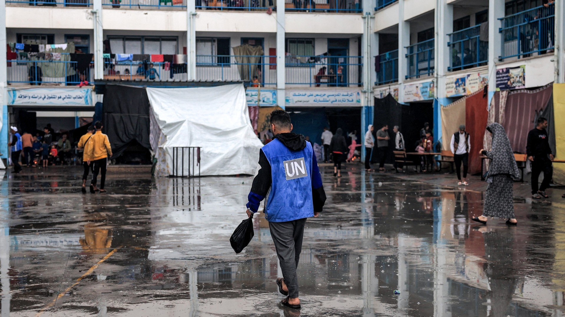 A man walks with a gilet bearing the logo of the UN at school run by the United Nations Relief and Works Agency for Palestine Refugees in the Near East (Unrwa) in Rafah in the southern Gaza Strip on 14 November 2023 (AFP/Said Khatib)